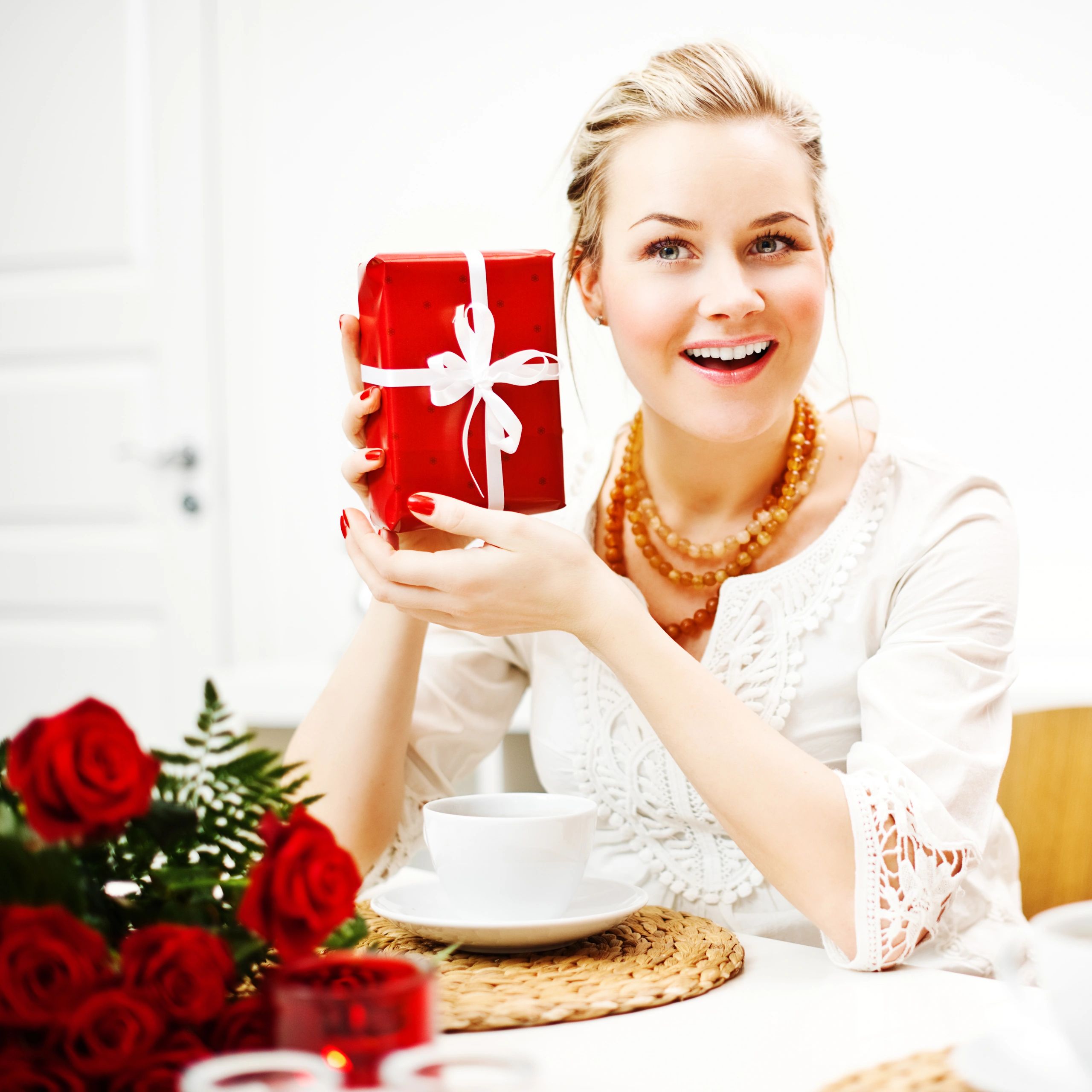 Person holding a gift, joyful candid portrait.