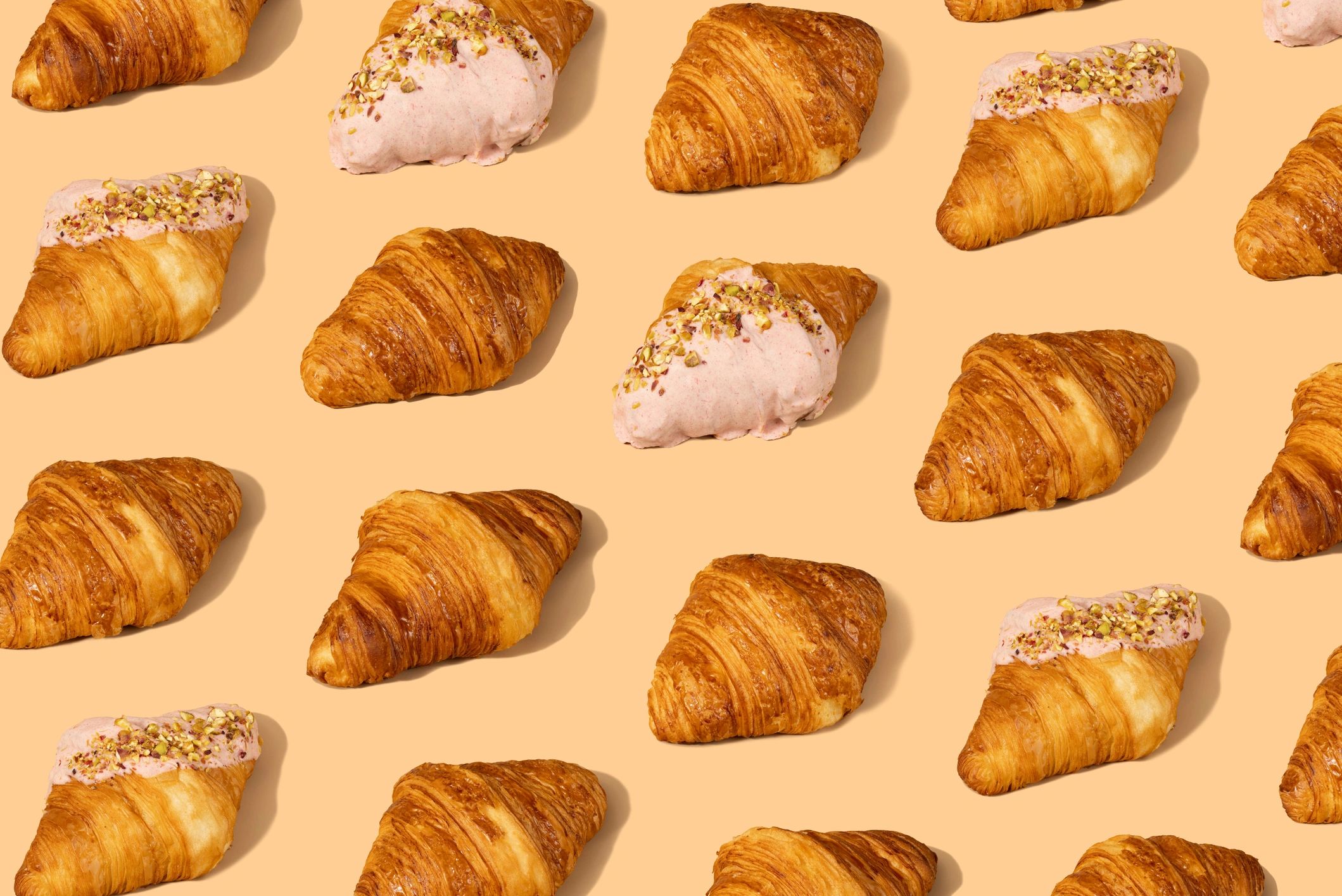 Fresh croissant on a pastel background, a delivery-friendly pastry vibe