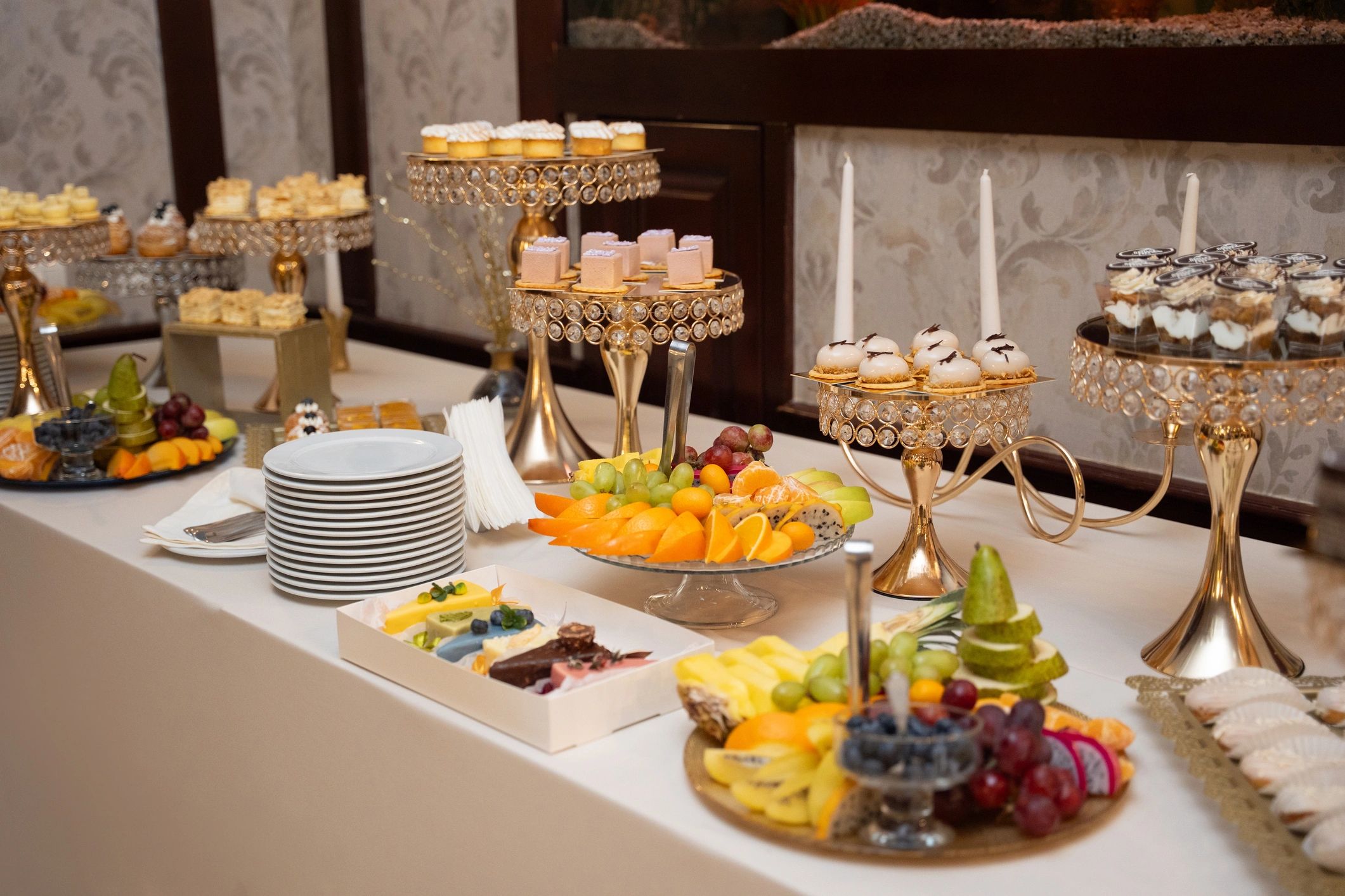 A curated dessert display with pastries and sweets, styled like a celebratory bakery spread.